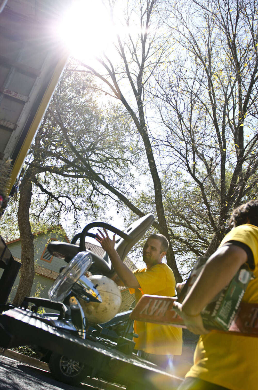 SpaceMan crew loading furniture into the truck on a sunny Austin moving day